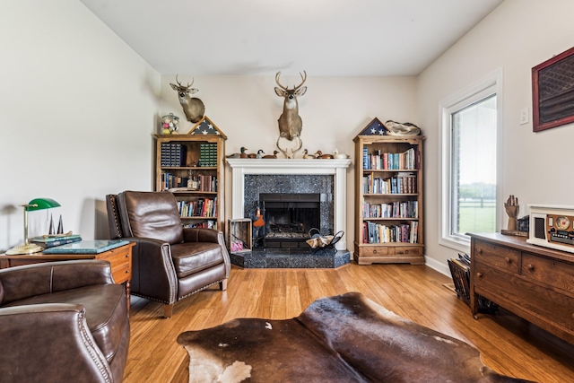 interior space with a high end fireplace and light hardwood / wood-style flooring