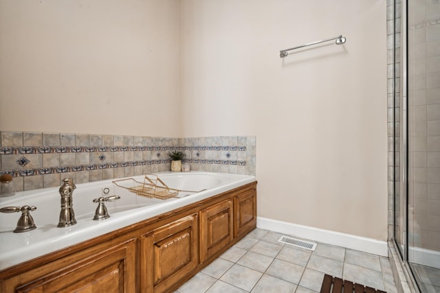 bathroom with tile patterned flooring and a tub