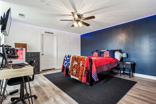 bedroom with ceiling fan and wood-type flooring