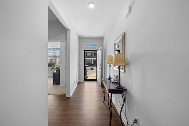 hallway with dark hardwood / wood-style floors