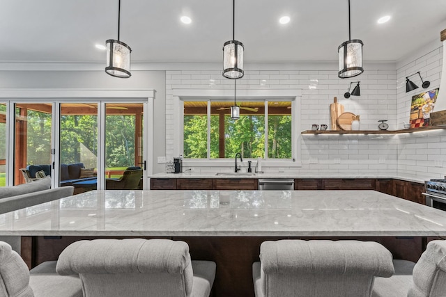 kitchen featuring pendant lighting, sink, and a breakfast bar area