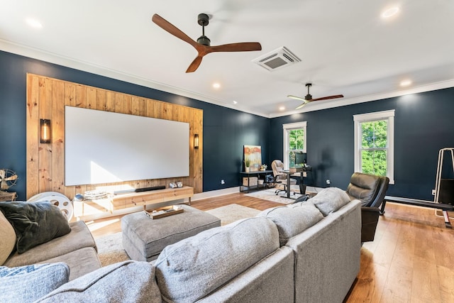 cinema with crown molding, light hardwood / wood-style floors, and ceiling fan