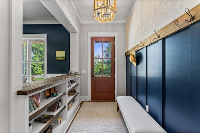 mudroom with crown molding, a healthy amount of sunlight, and an inviting chandelier