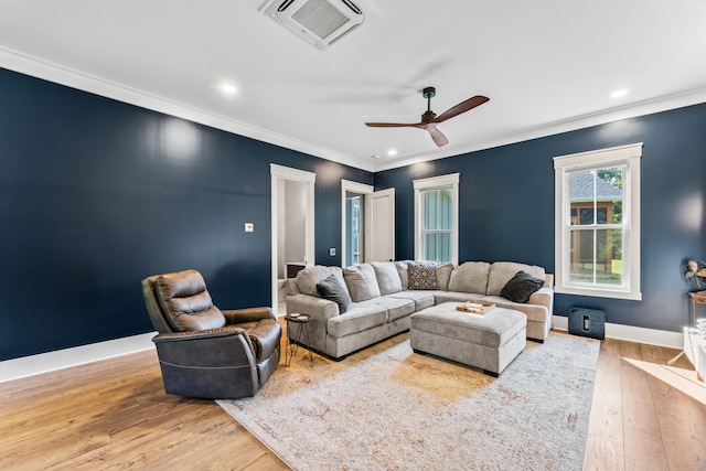 living room featuring crown molding, ceiling fan, and light wood-type flooring