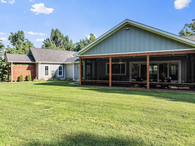 rear view of property with a yard