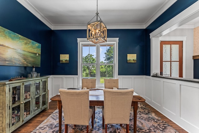 dining space featuring a notable chandelier, ornamental molding, and dark hardwood / wood-style floors