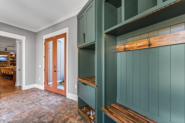 mudroom with crown molding and french doors