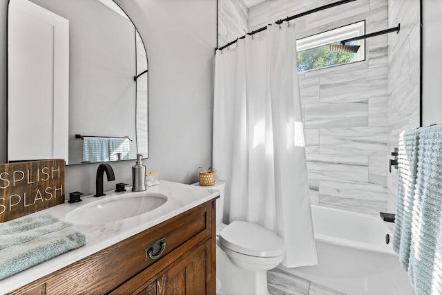 full bathroom with vanity, shower / tub combo, and toilet