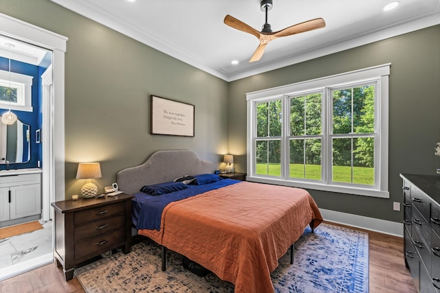 bedroom with ornamental molding, ensuite bathroom, ceiling fan, and light hardwood / wood-style floors