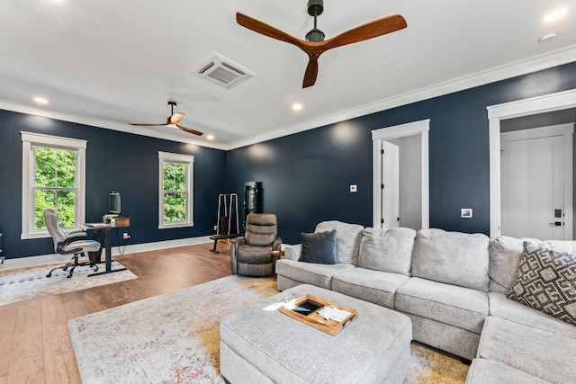 living room with ornamental molding, ceiling fan, and light hardwood / wood-style floors