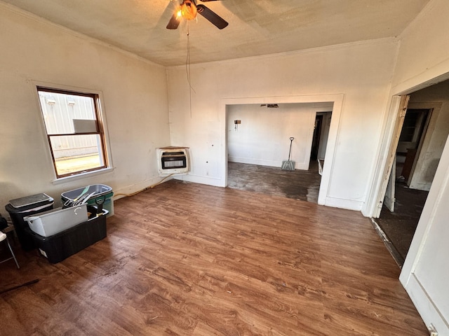 unfurnished living room featuring heating unit, crown molding, dark hardwood / wood-style floors, and ceiling fan