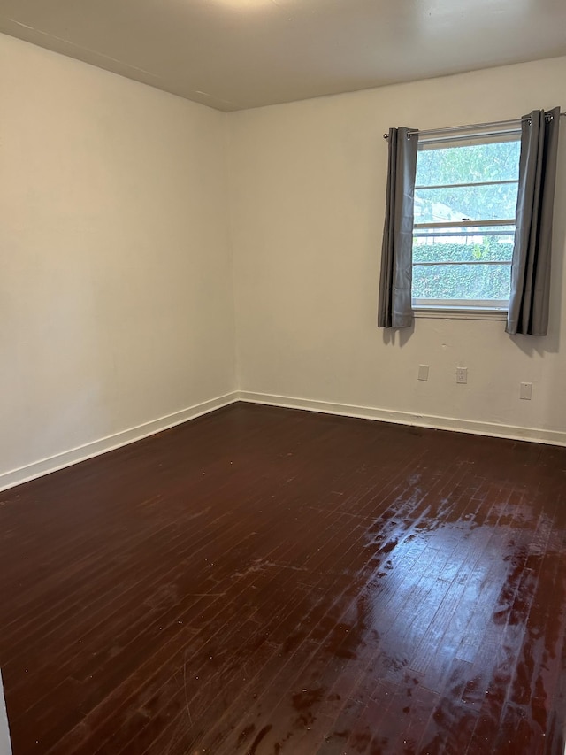 unfurnished room featuring dark hardwood / wood-style flooring