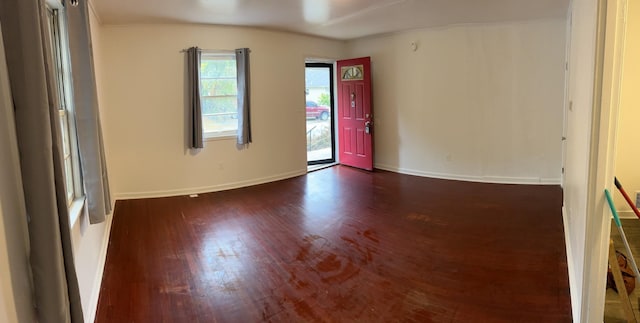 unfurnished room with dark hardwood / wood-style flooring