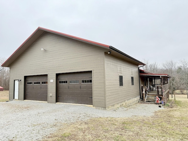 view of home's exterior with a detached garage