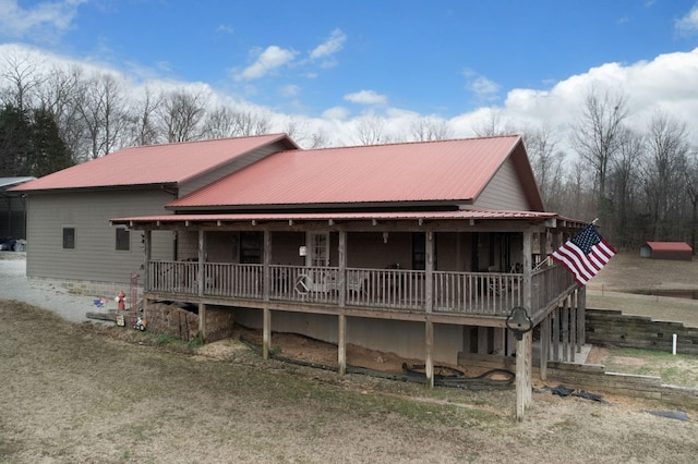 back of property featuring metal roof