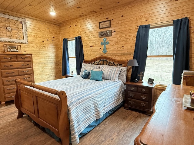 bedroom with wooden ceiling and wood finished floors