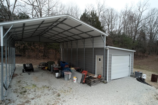 exterior space with driveway and a detached carport