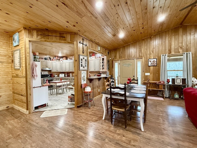 dining space featuring wooden ceiling, vaulted ceiling, wooden walls, and wood finished floors