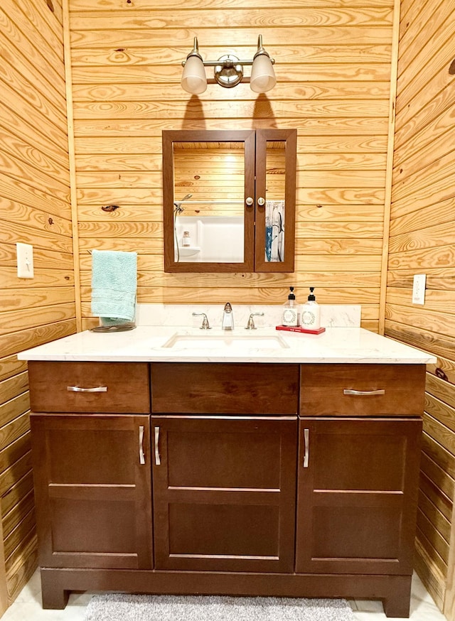 bathroom with vanity and wooden walls