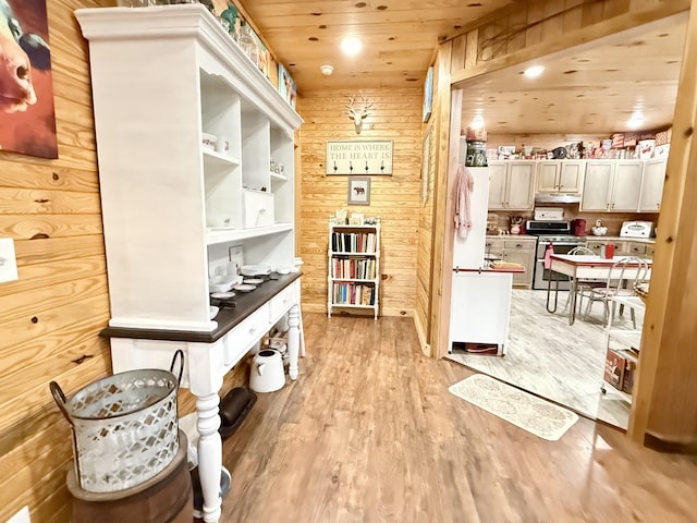 interior space with wood ceiling, wooden walls, light wood-style flooring, and recessed lighting