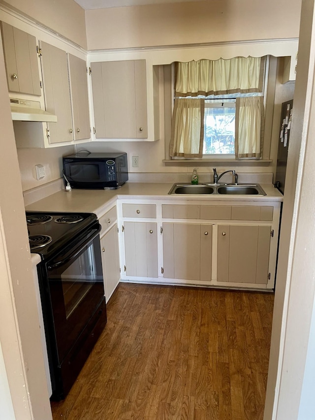 kitchen featuring sink, black appliances, and dark hardwood / wood-style floors