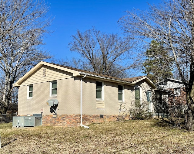 view of property exterior with central AC unit and a yard