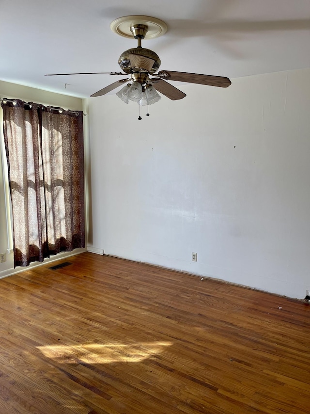 spare room with ceiling fan and hardwood / wood-style floors