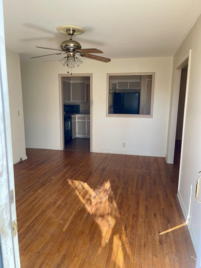 spare room with dark hardwood / wood-style floors and ceiling fan