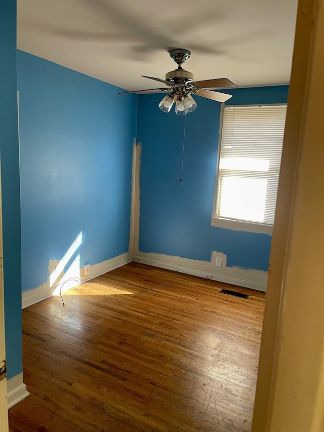 empty room with wood-type flooring and ceiling fan