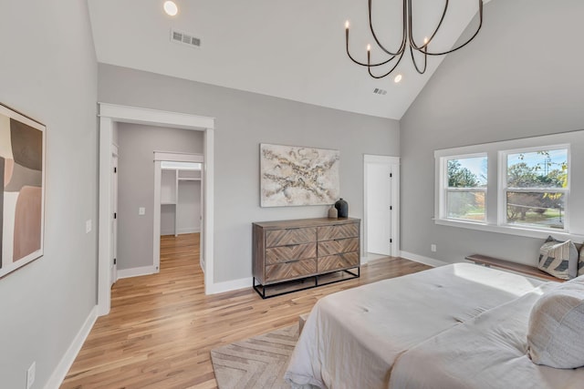 bedroom featuring high vaulted ceiling and light hardwood / wood-style floors