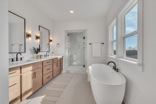 bathroom featuring tile patterned floors, vanity, and plus walk in shower