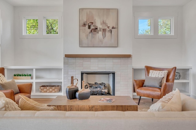 living room featuring a tiled fireplace