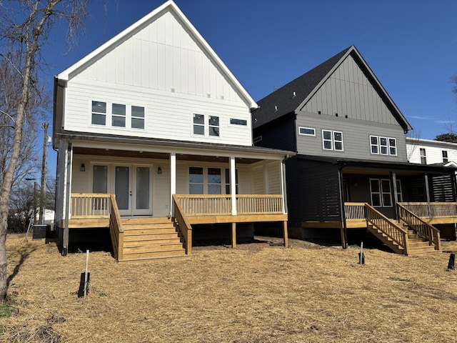 view of front facade with central AC unit, french doors, and covered porch