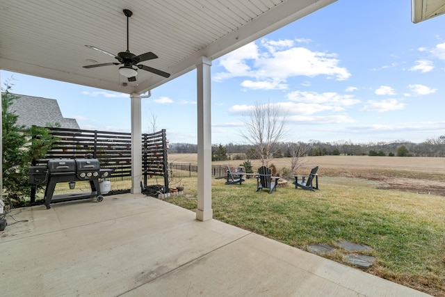 view of patio / terrace with a rural view, grilling area, and ceiling fan