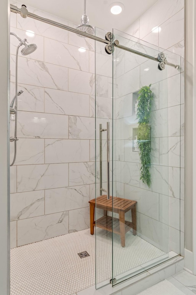 bathroom featuring a shower with door