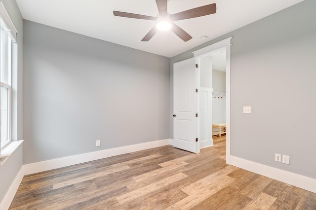 spare room with light hardwood / wood-style flooring and ceiling fan