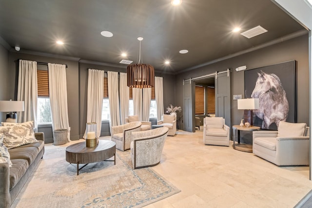 living room featuring ornamental molding and a barn door