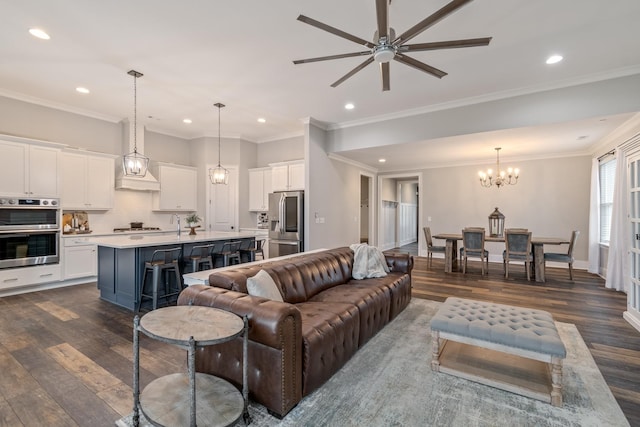 living room featuring ornamental molding, dark hardwood / wood-style flooring, and ceiling fan with notable chandelier