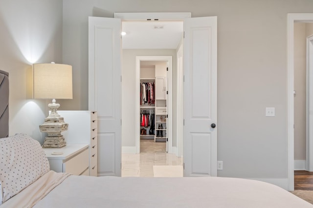 bedroom featuring a walk in closet and a closet