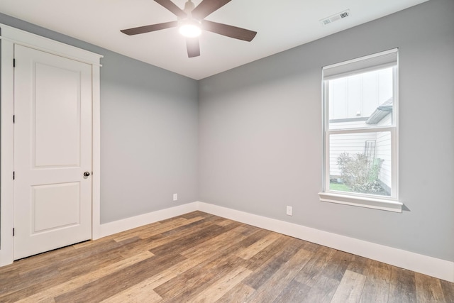 empty room featuring wood-type flooring and ceiling fan