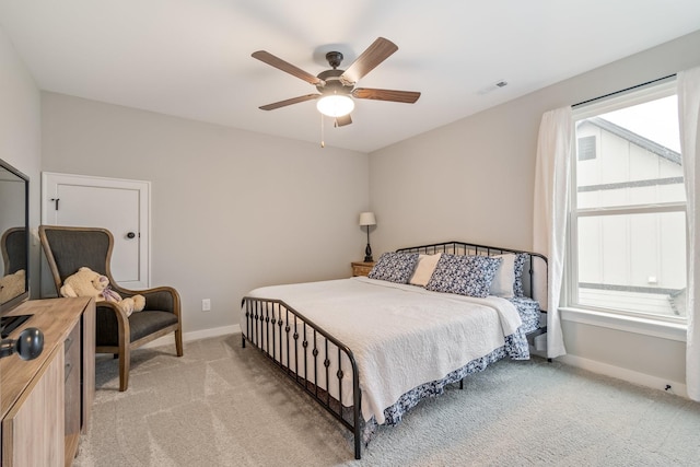 bedroom with light colored carpet and ceiling fan