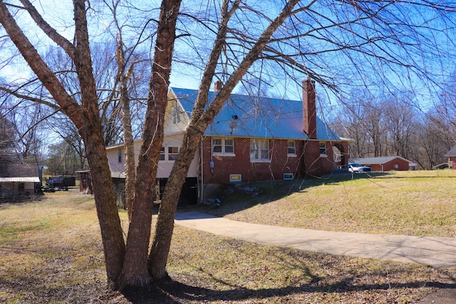 view of side of home with a yard