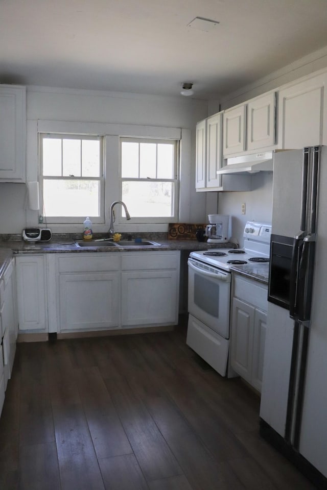 kitchen featuring fridge with ice dispenser, electric range, and white cabinetry