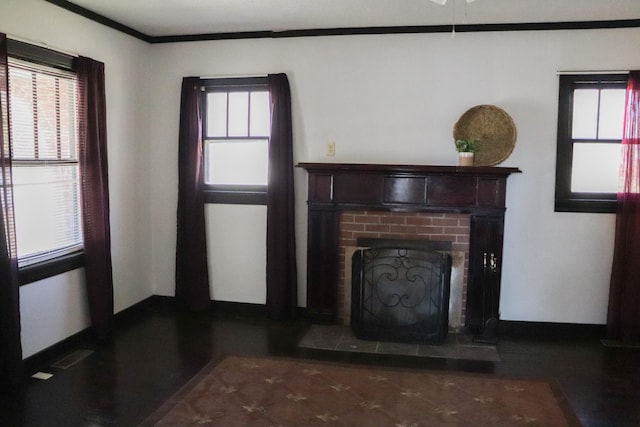 unfurnished living room featuring crown molding and a brick fireplace