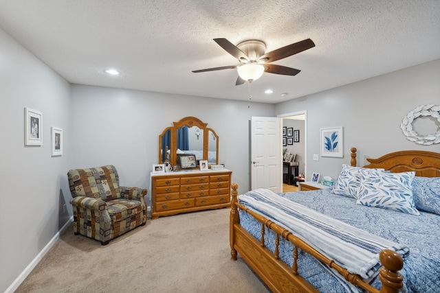 carpeted bedroom with ceiling fan and a textured ceiling