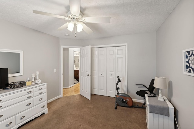 sitting room with ceiling fan, light colored carpet, and a textured ceiling