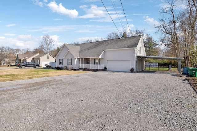 ranch-style home with a garage, a front yard, a carport, and covered porch