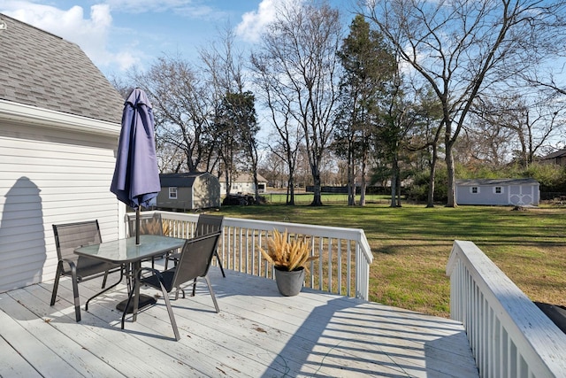 deck with a yard and a shed