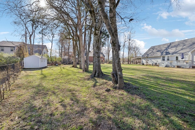 view of yard with a storage shed and a deck