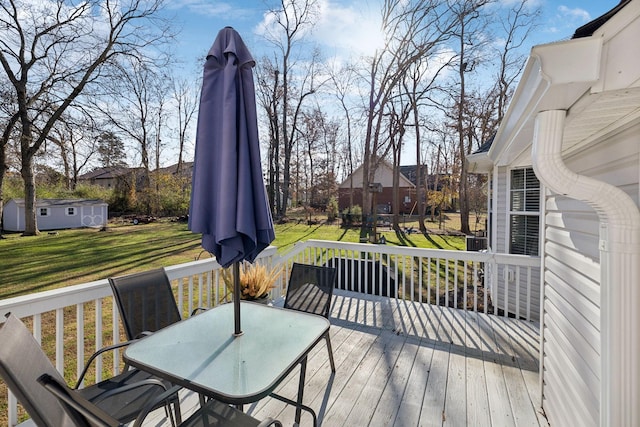 wooden terrace with a lawn